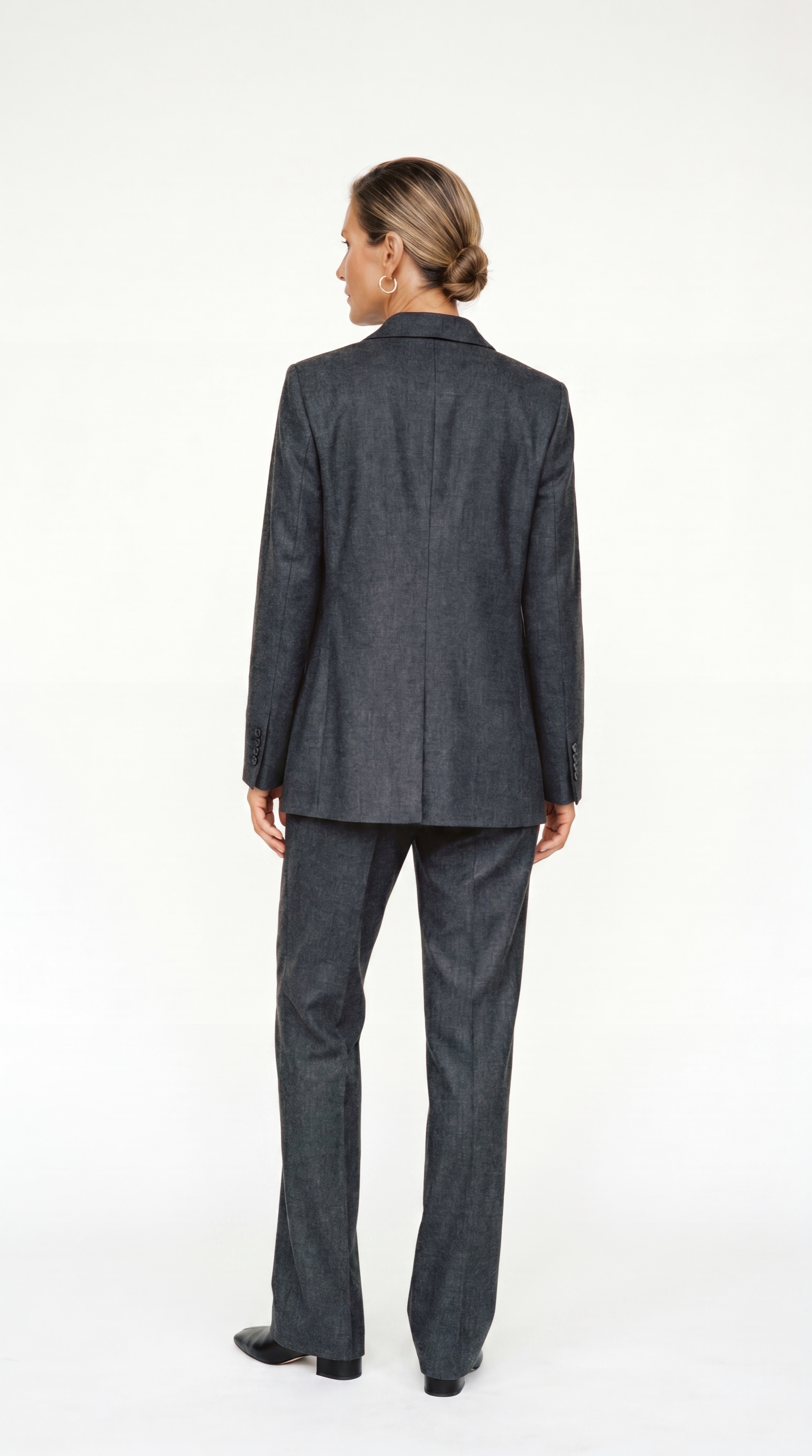Resident in a charcoal tailored suit, back